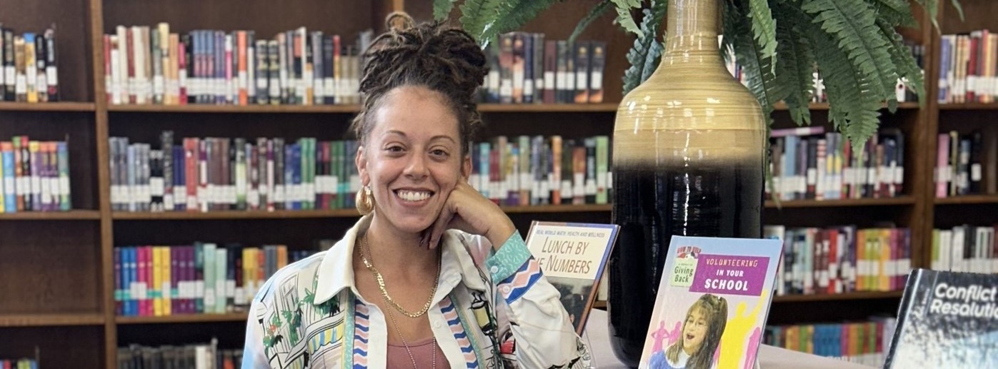 A Smiling Woman standing in the Library