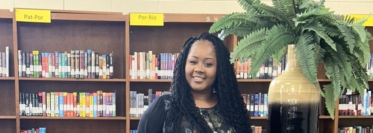 A Smiling Woman standing in the Library